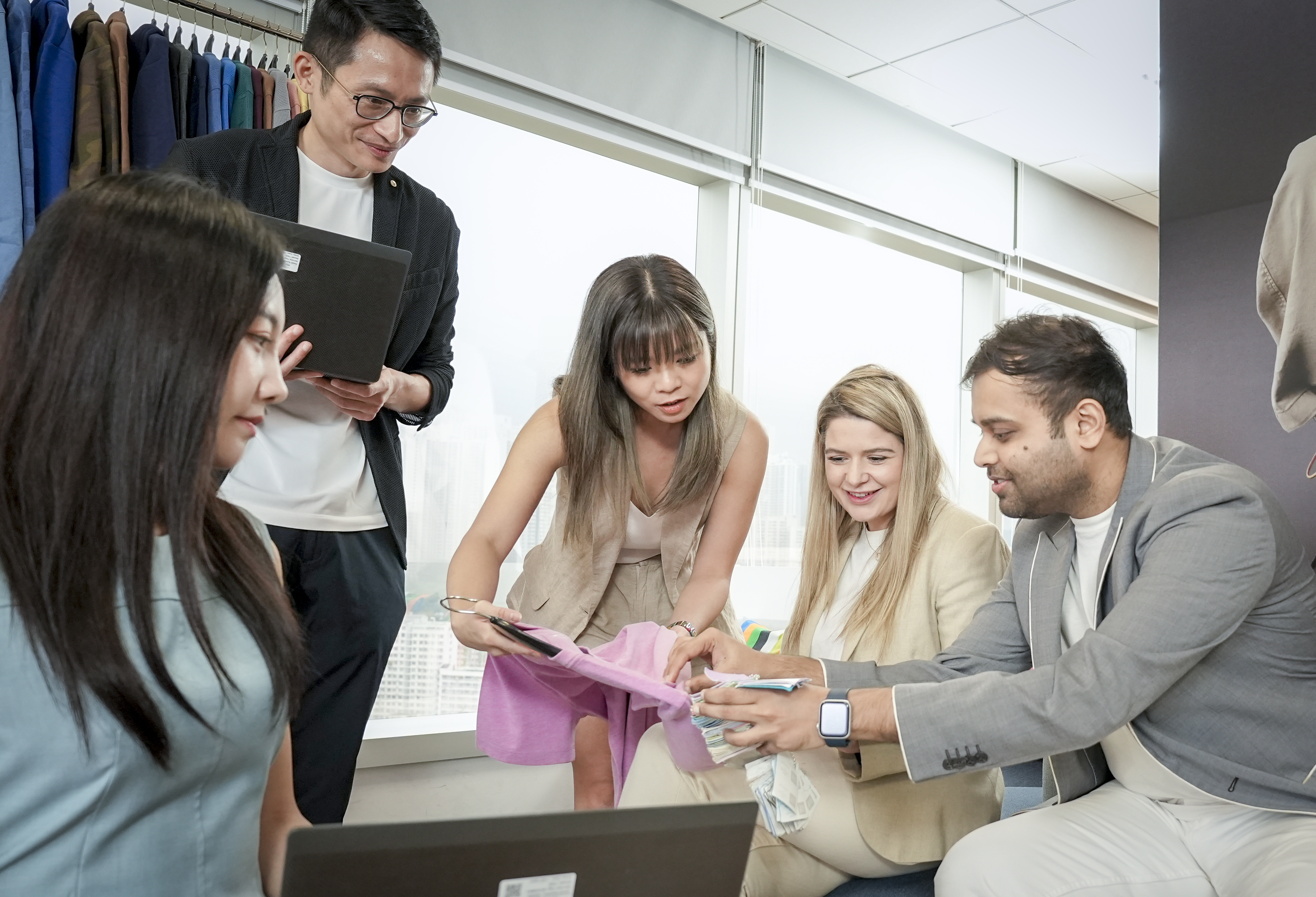 Employees inspecting garment