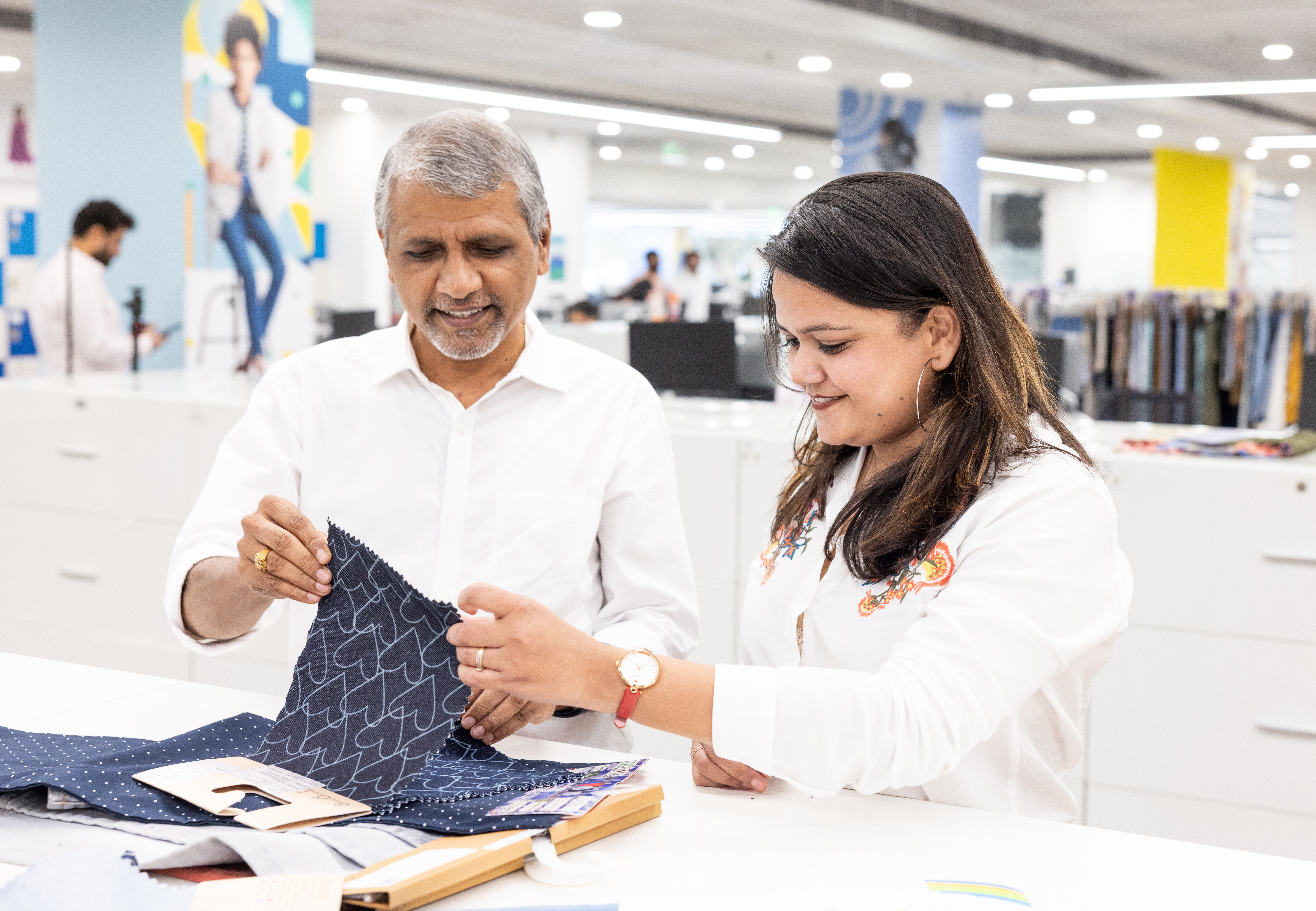 Employees looking over fabric swatches