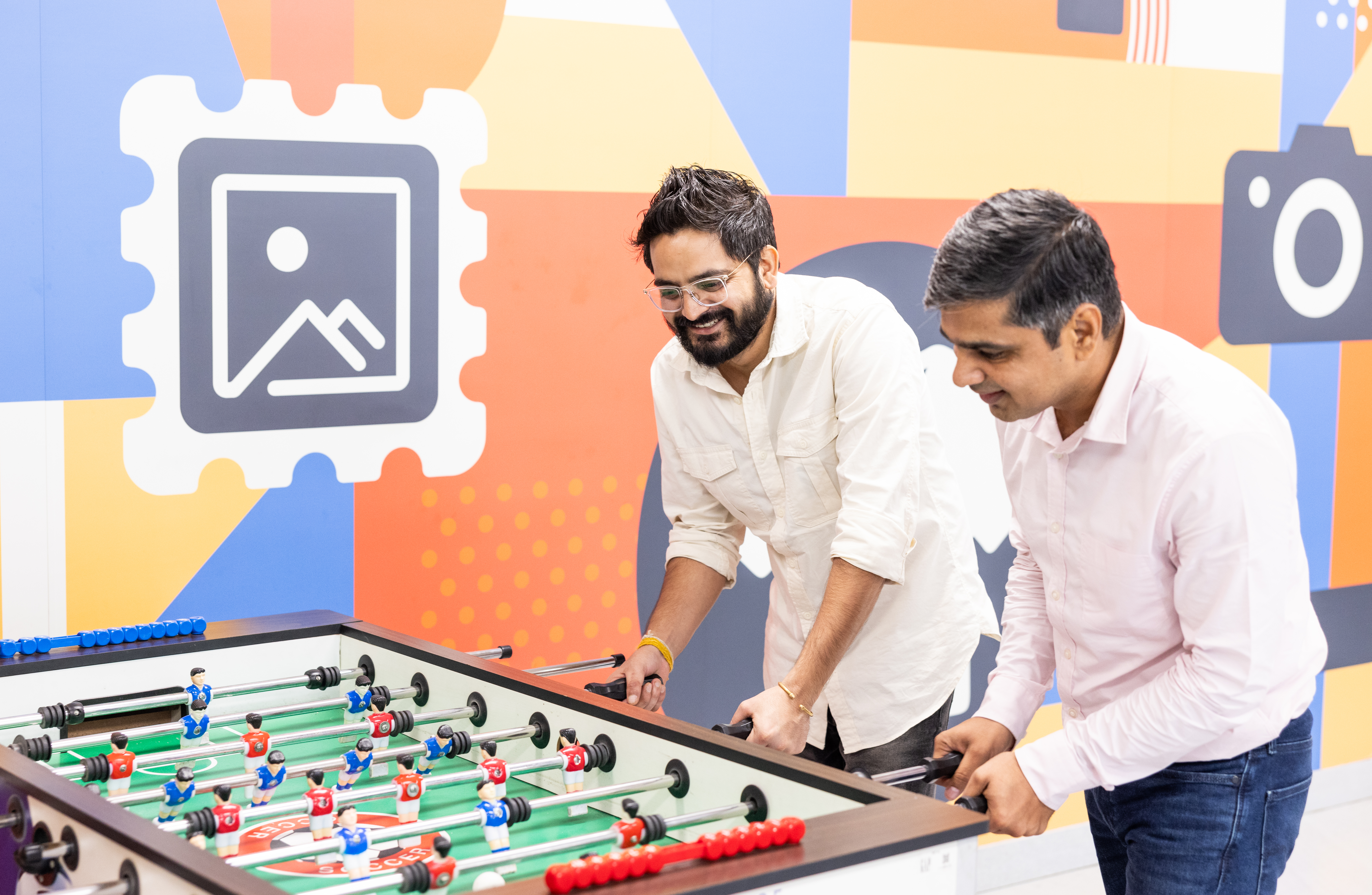Employees enjoying a game of foosball