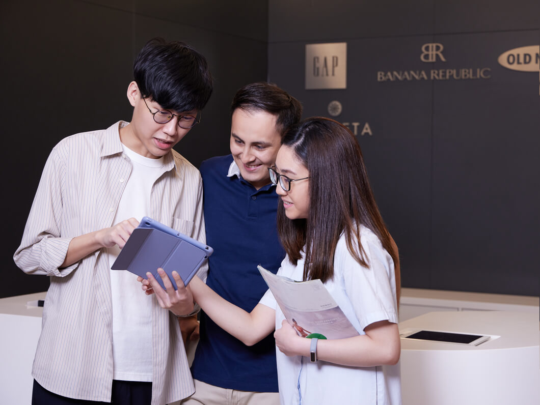 Three Employees Looking at an IPad