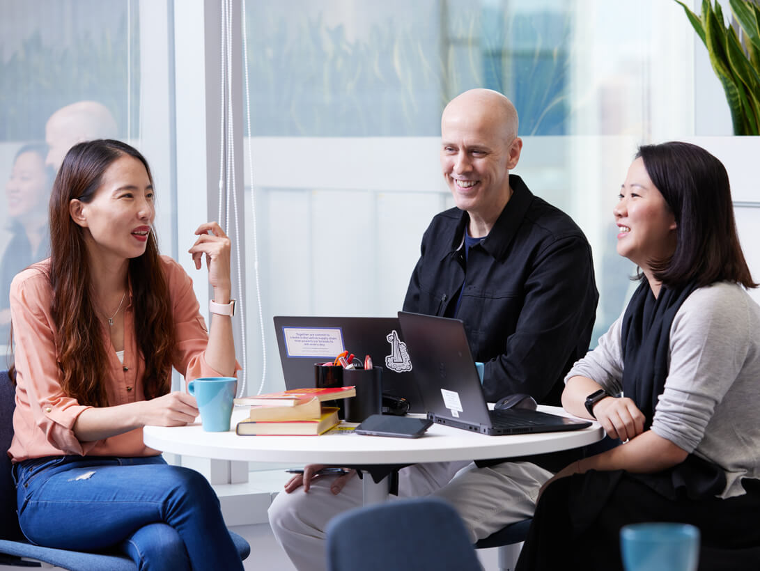 Group of Employees Working Around a Round Table