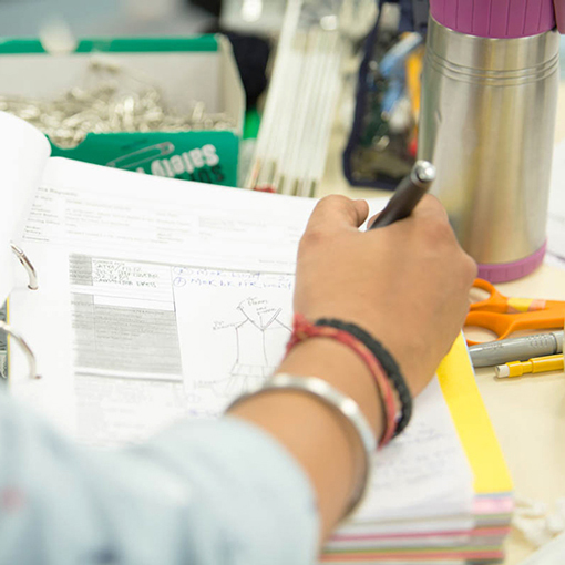 Designer writing down measurements 