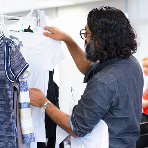 Designer looking through clothes 
