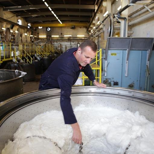 Man stirring cotton fibers 