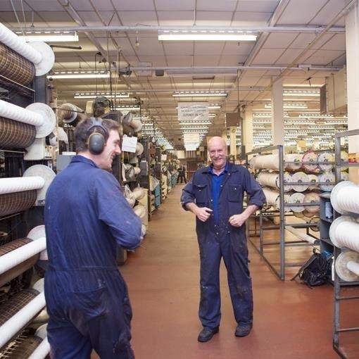 two men laughing while they work 