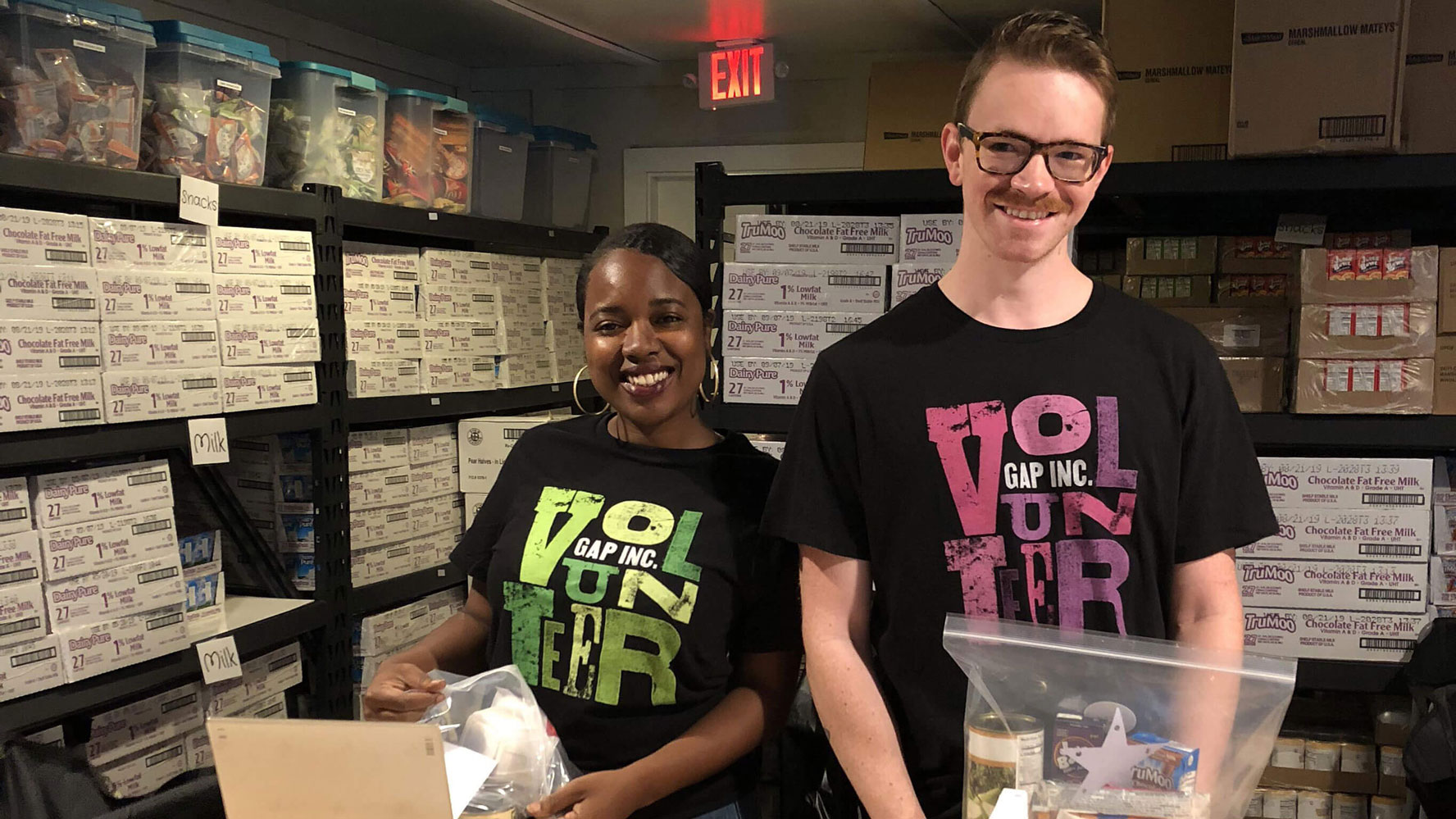 Two store employees volunteering